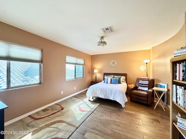 bedroom with hardwood / wood-style flooring