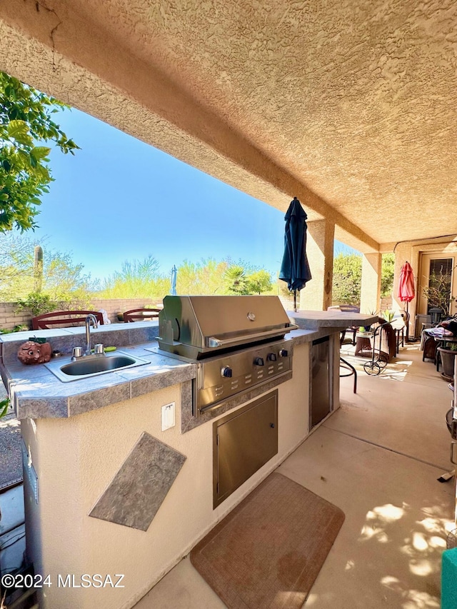 view of patio featuring area for grilling and sink