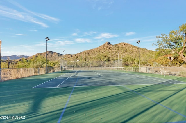 view of tennis court featuring a mountain view