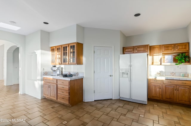 kitchen with white fridge with ice dispenser