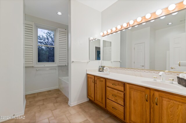 bathroom with vanity and a bathing tub