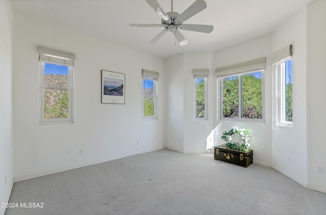 unfurnished room with ceiling fan and light colored carpet