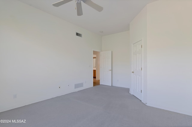 carpeted empty room featuring ceiling fan