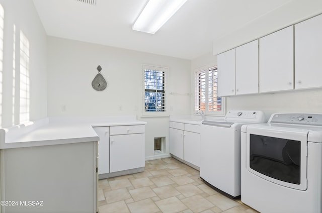 laundry room featuring cabinets, washer and dryer, and sink