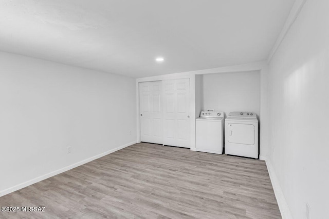 laundry room with light wood finished floors, recessed lighting, baseboards, and washing machine and clothes dryer