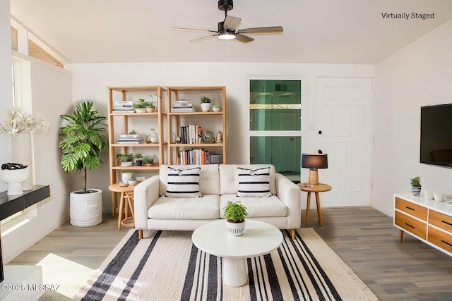 living area featuring wood finished floors and a ceiling fan