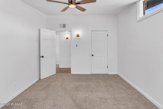 unfurnished bedroom featuring a ceiling fan, baseboards, visible vents, and carpet flooring