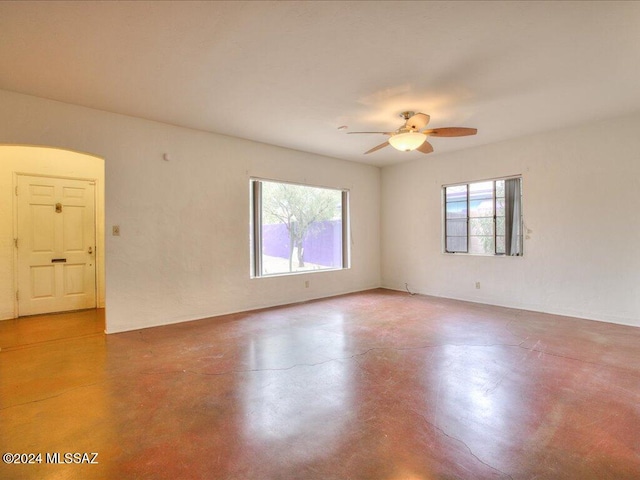 unfurnished room with concrete flooring and ceiling fan