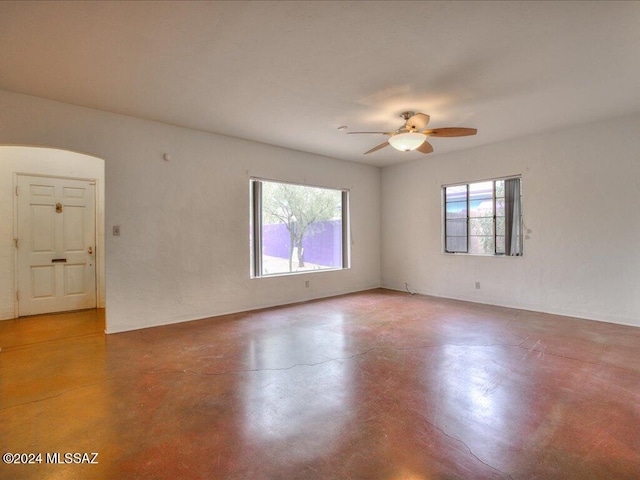 spare room featuring concrete flooring and ceiling fan