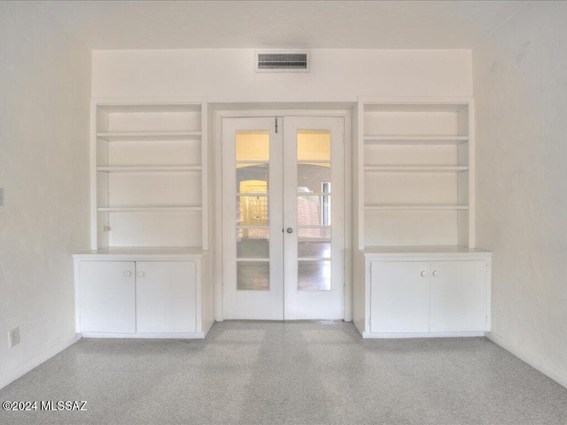 unfurnished living room featuring french doors