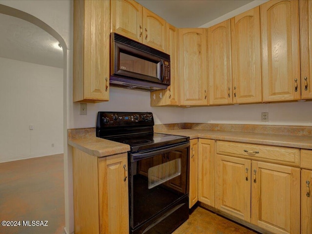 kitchen featuring light brown cabinets and black appliances