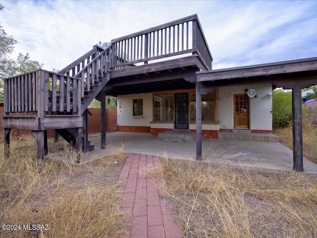 back of house featuring a patio area and a deck