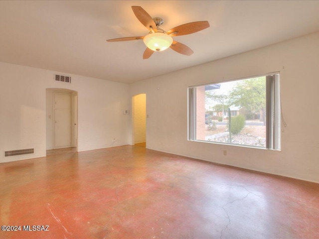 spare room featuring concrete floors and ceiling fan