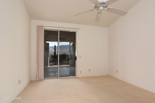 carpeted empty room with ceiling fan and a mountain view