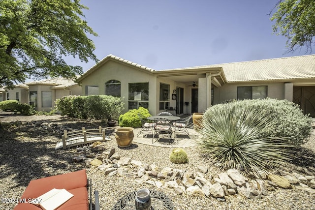 back of house featuring ceiling fan and a patio area