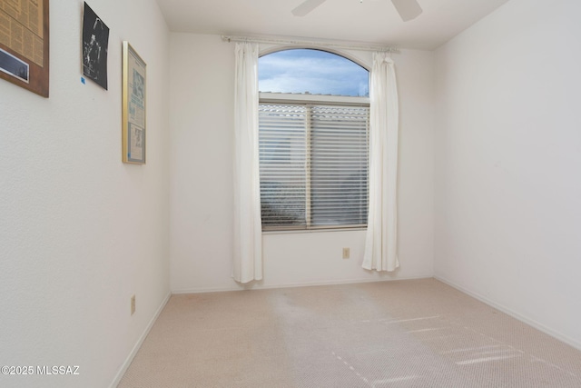 spare room with carpet flooring and ceiling fan