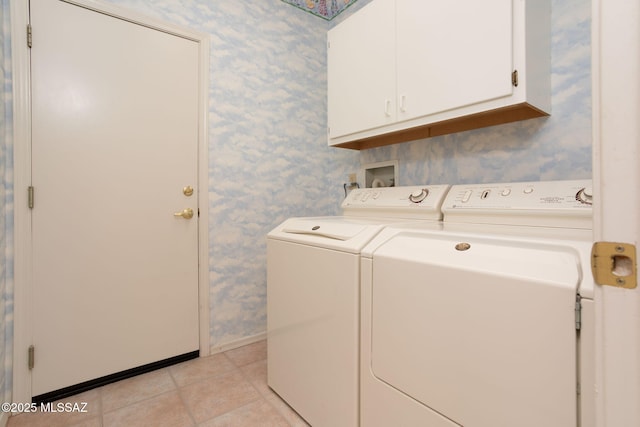 laundry room featuring washer and dryer and cabinets