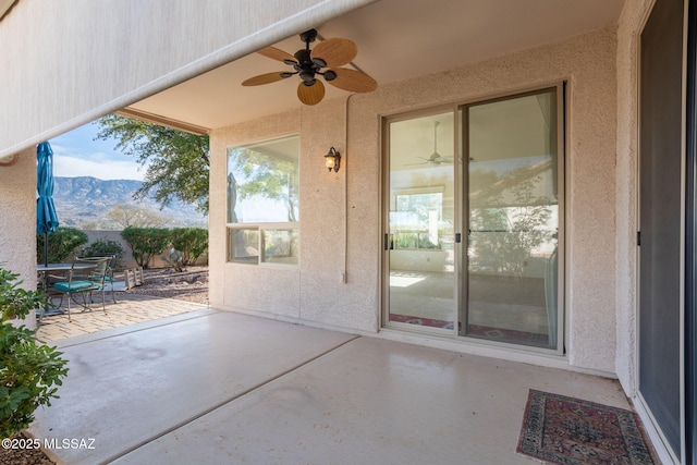 view of patio featuring a mountain view and ceiling fan