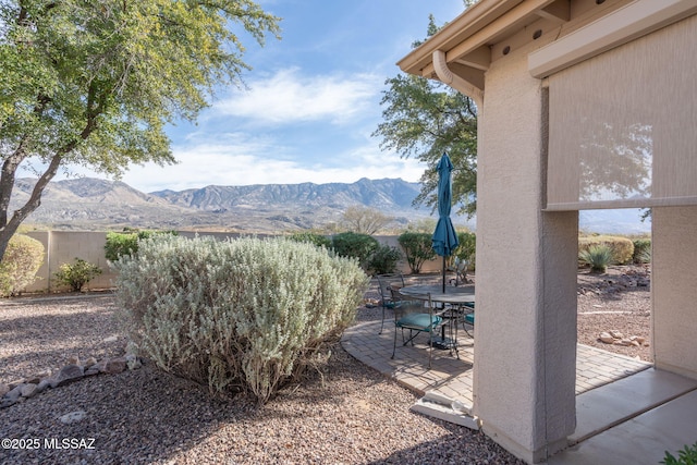 view of yard with a mountain view and a patio