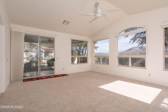 unfurnished sunroom with ceiling fan, a mountain view, and lofted ceiling