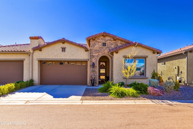 mediterranean / spanish-style home with a garage