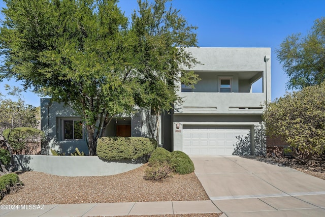 view of front facade featuring a garage and a balcony