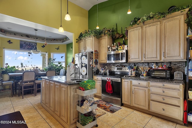 kitchen featuring tasteful backsplash, hanging light fixtures, light tile patterned floors, appliances with stainless steel finishes, and a center island