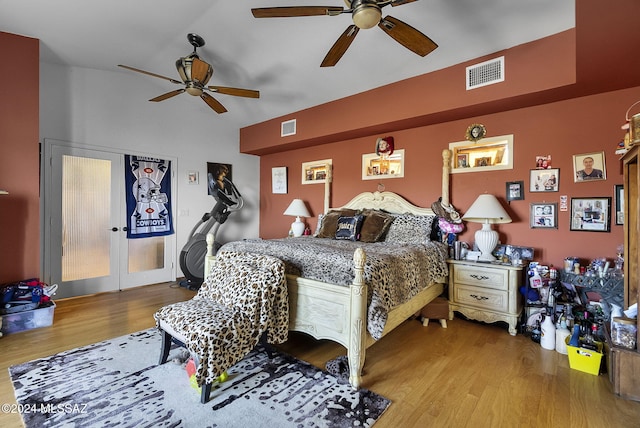 bedroom featuring lofted ceiling, hardwood / wood-style flooring, and ceiling fan