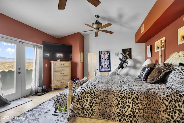 bedroom featuring ceiling fan, access to exterior, vaulted ceiling, light hardwood / wood-style flooring, and french doors