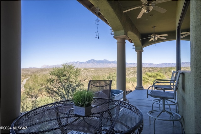 exterior space featuring a mountain view and ceiling fan