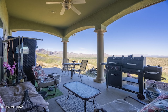 view of patio / terrace with a mountain view, grilling area, and ceiling fan