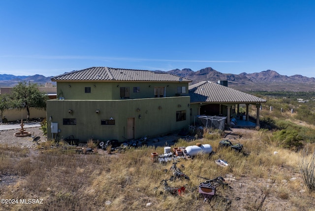 back of house featuring a mountain view