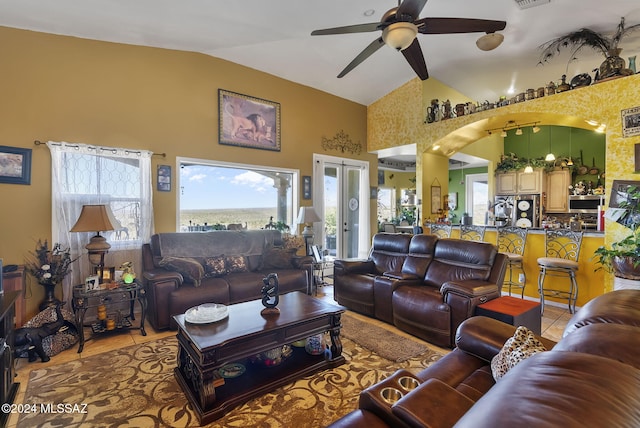 tiled living room featuring ceiling fan and lofted ceiling