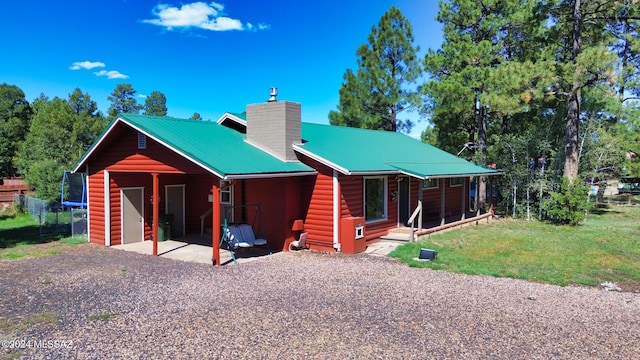 view of front of house with a patio area and a front lawn