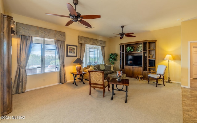 carpeted living room with ceiling fan