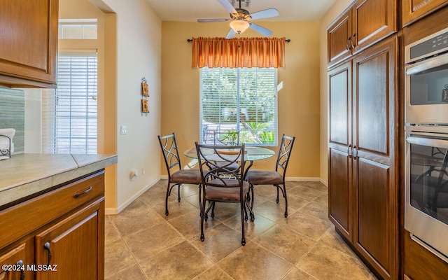 dining space featuring light tile patterned floors and ceiling fan