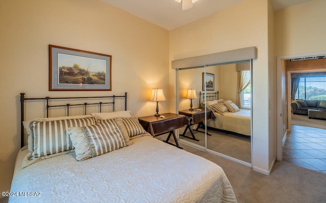 bedroom with a towering ceiling, a closet, carpet flooring, and ceiling fan