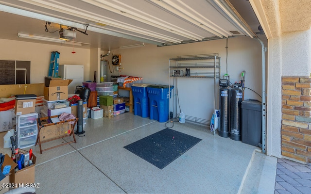 garage featuring a garage door opener and white refrigerator