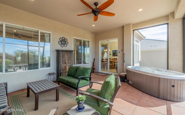 view of patio featuring a hot tub, an outdoor hangout area, and ceiling fan