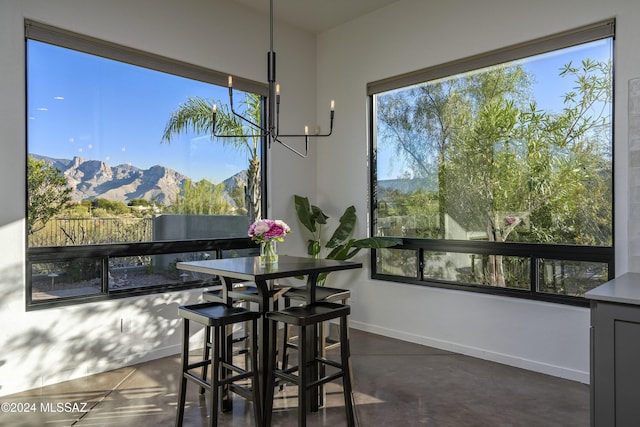 dining area with a mountain view and a healthy amount of sunlight