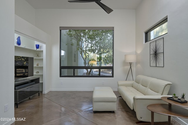 sitting room with concrete floors and ceiling fan