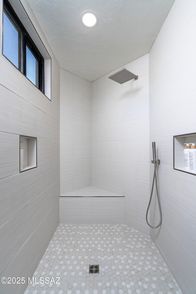 bathroom with a tile shower