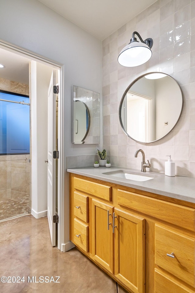 bathroom featuring decorative backsplash, vanity, concrete flooring, and tile walls