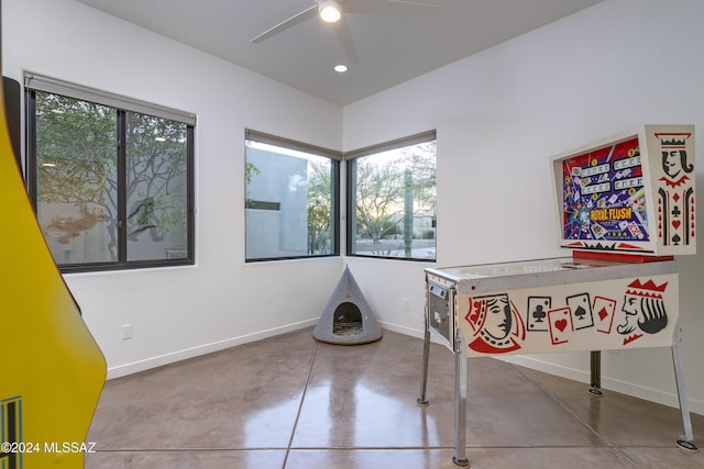 interior space featuring ceiling fan, concrete floors, and a healthy amount of sunlight