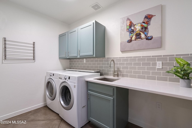 washroom featuring cabinets, sink, and washer and dryer