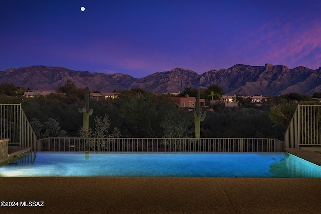 pool at dusk with a mountain view