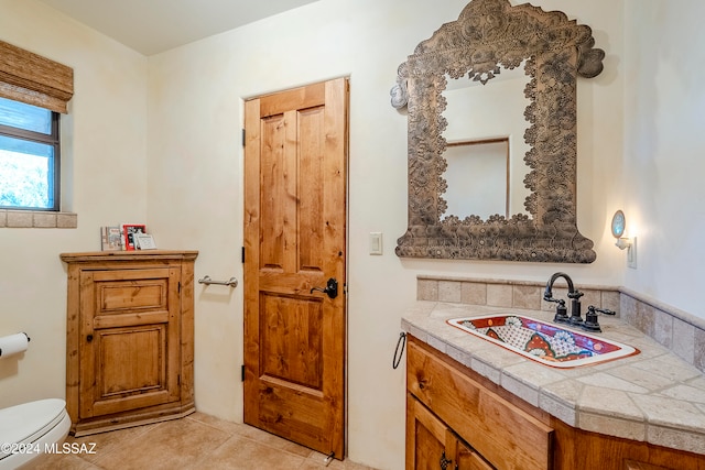 bathroom featuring tile patterned floors, vanity, and toilet