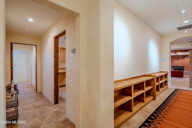 hall with light tile patterned floors