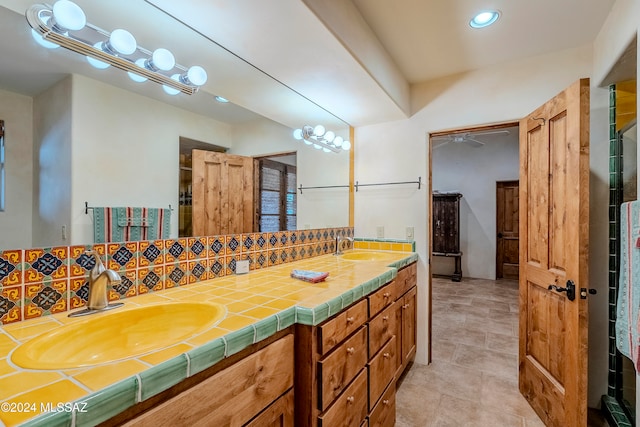 bathroom featuring backsplash, tile patterned floors, and vanity