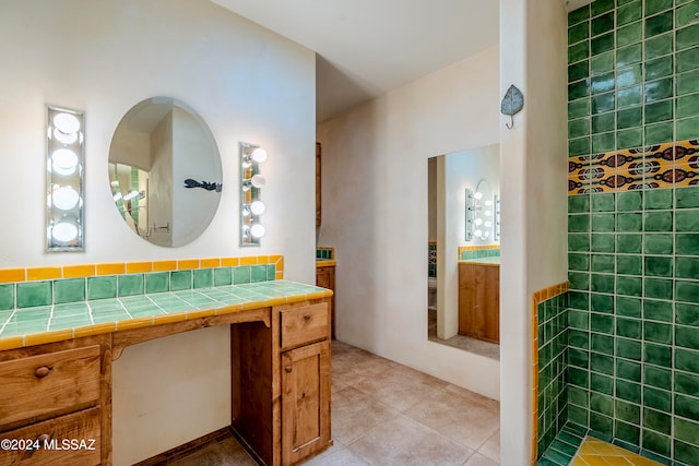 bathroom featuring tile patterned flooring and vanity